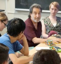 Lee Perlman (in maroon shirt) lectures on the philosophy of love at MIT. Perlman also teaches classes at Massachusetts prisons with a mix of both MIT students and prison inmates. MIT News